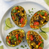 Stuffed avocado boats filled with The Better Butchers Chorizo-style ground, farro, black beans, corn, bell peppers, and cilantro, served with lime
