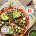 Flatbread pizza topped with The Better Butchers Chorizo plant-based ground, avocado, and red onion, cut into slices.
